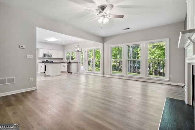 1931 Abinger Way, Lawrenceville, GA 30043 - unfurnished living room with baseboards, ceiling fan, and visible vents
