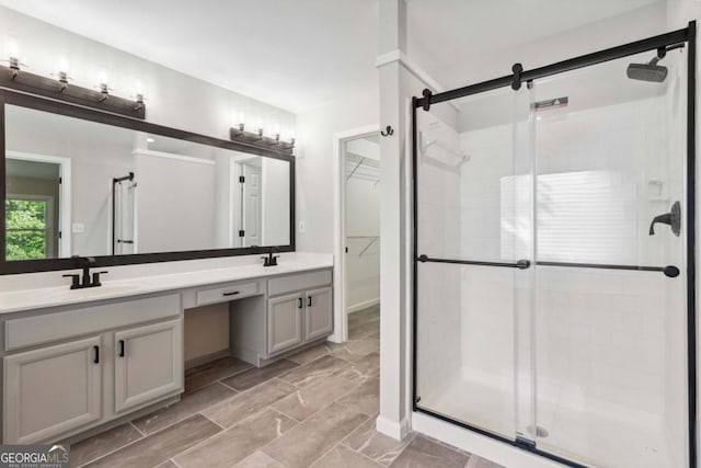 1931 Abinger Way, Lawrenceville, GA 30043 - bathroom featuring a sink, a stall shower, double vanity, and a spacious closet