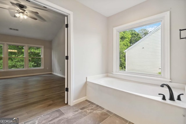 1931 Abinger Way, Lawrenceville, GA 30043 - bathroom with baseboards, visible vents, a bath, and a wealth of natural light