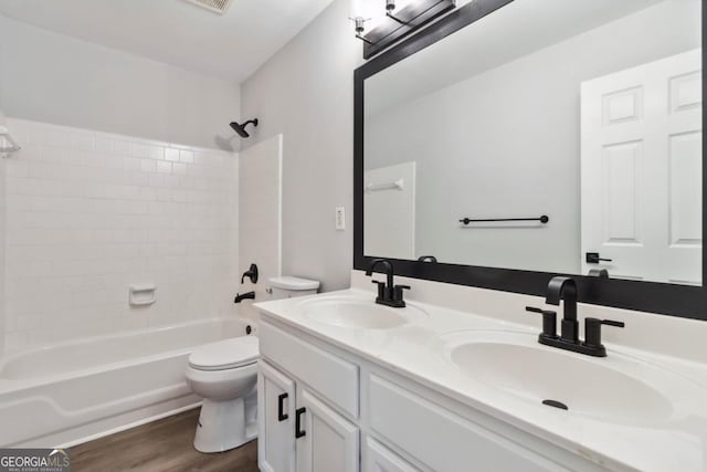 1931 Abinger Way, Lawrenceville, GA 30043 - bathroom featuring toilet, shower / bath combination, a sink, and wood finished floors