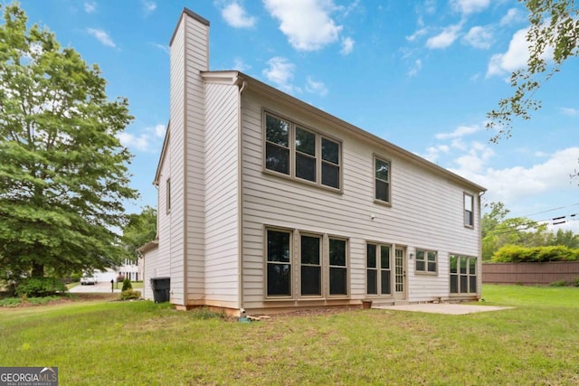 1931 Abinger Way, Lawrenceville, GA 30043 - back of property featuring a yard, a patio, fence, and a chimney