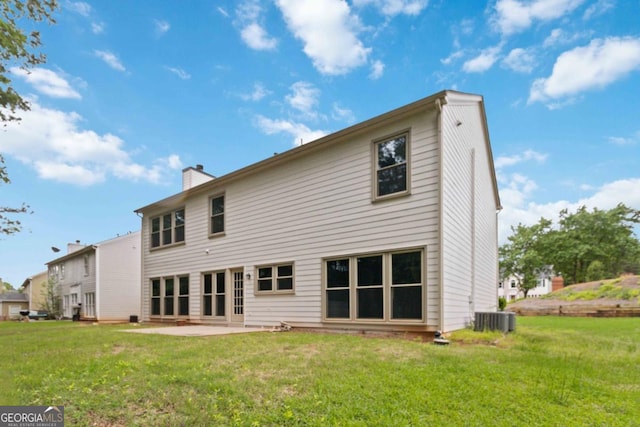1931 Abinger Way, Lawrenceville, GA 30043 - rear view of property featuring a patio, a chimney, a yard, and central AC