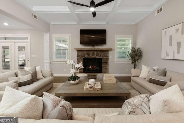 living area with visible vents, wood finished floors, beamed ceiling, ceiling fan, and coffered ceiling