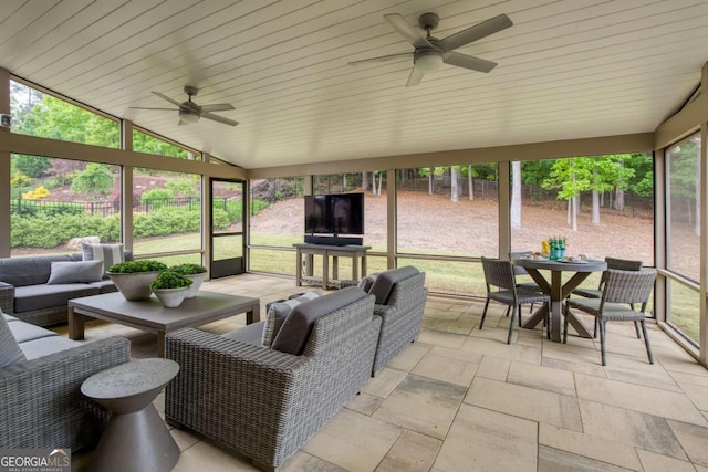 sunroom with ceiling fan, outdoor lounge area, and outdoor dining space