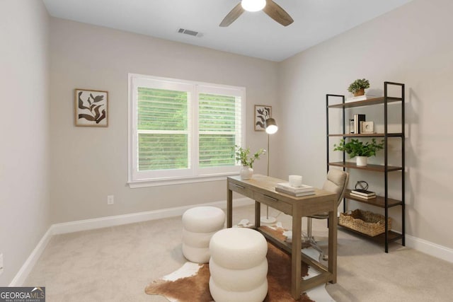 carpeted office with ceiling fan, visible vents, and baseboards