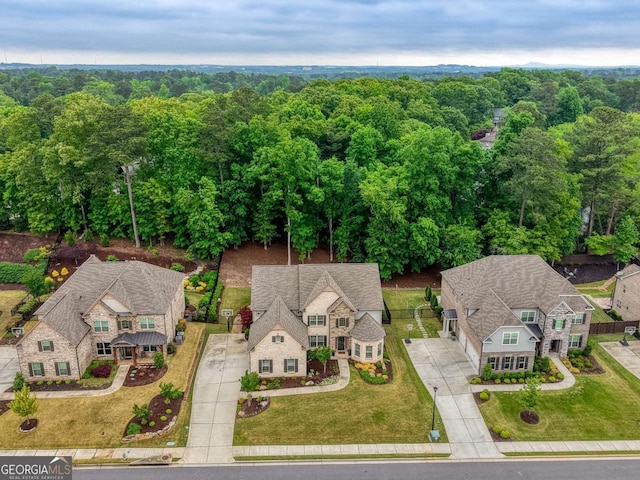 bird's eye view with a wooded view