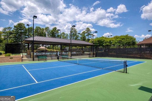 view of sport court featuring fence