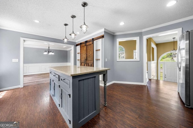 405 Maple Rdg, White, GA 30184 - kitchen with crown molding, freestanding refrigerator, a textured ceiling, and a barn door