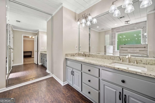 405 Maple Rdg, White, GA 30184 - bathroom with crown molding, visible vents, a sink, and wood finished floors