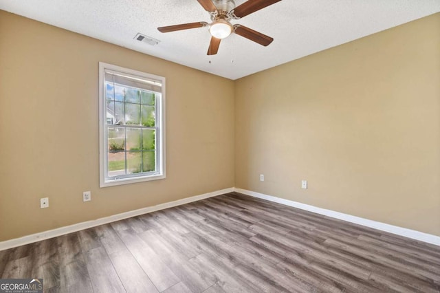 405 Maple Rdg, White, GA 30184 - unfurnished room with visible vents, a ceiling fan, dark wood finished floors, and baseboards