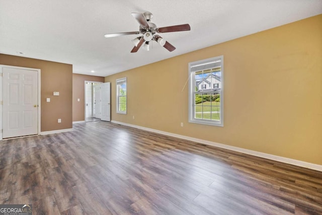 405 Maple Rdg, White, GA 30184 - unfurnished living room with a ceiling fan, baseboards, and dark wood-style floors