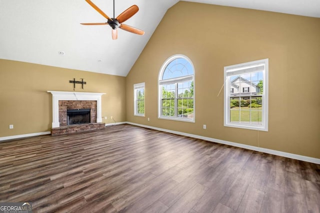 405 Maple Rdg, White, GA 30184 - unfurnished living room with baseboards, a stone fireplace, high vaulted ceiling, dark wood-type flooring, and a ceiling fan