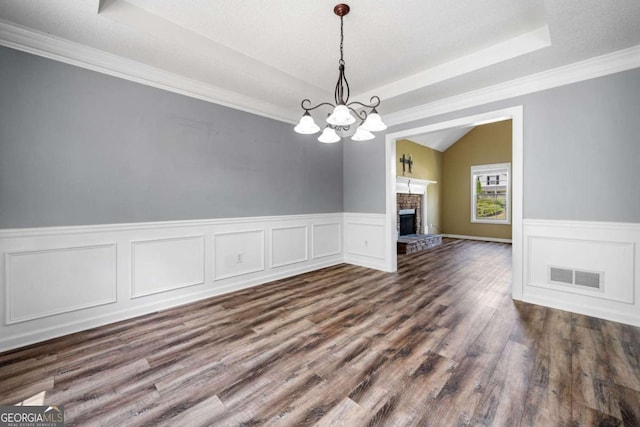 405 Maple Rdg, White, GA 30184 - unfurnished dining area featuring a chandelier, a wainscoted wall, dark wood-type flooring, a tray ceiling, and visible vents