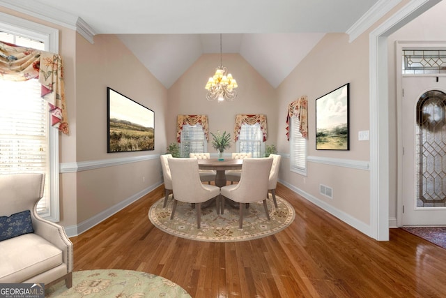 dining space featuring visible vents, baseboards, wood finished floors, and a chandelier