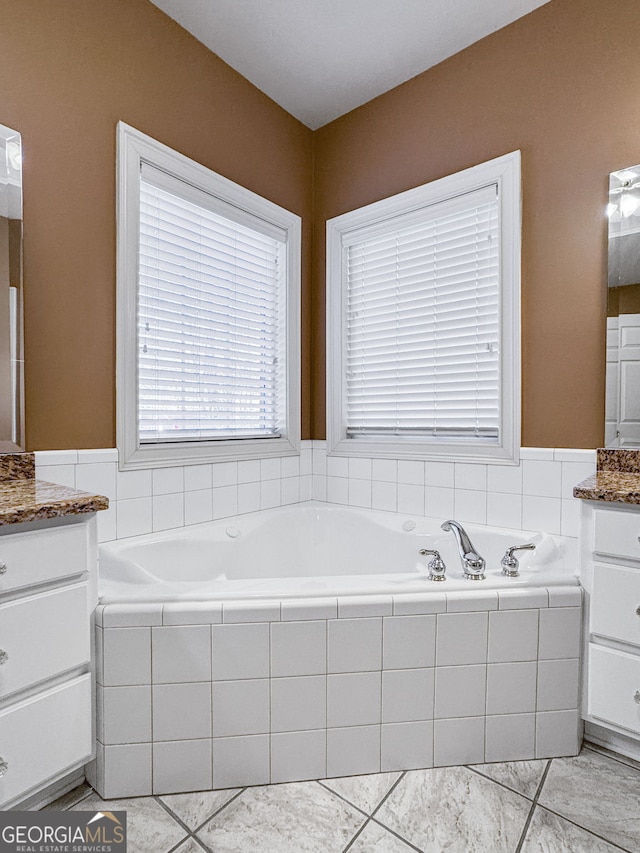 bathroom with a garden tub and vanity