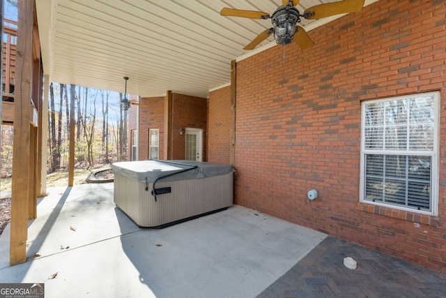 view of patio / terrace featuring ceiling fan and a hot tub