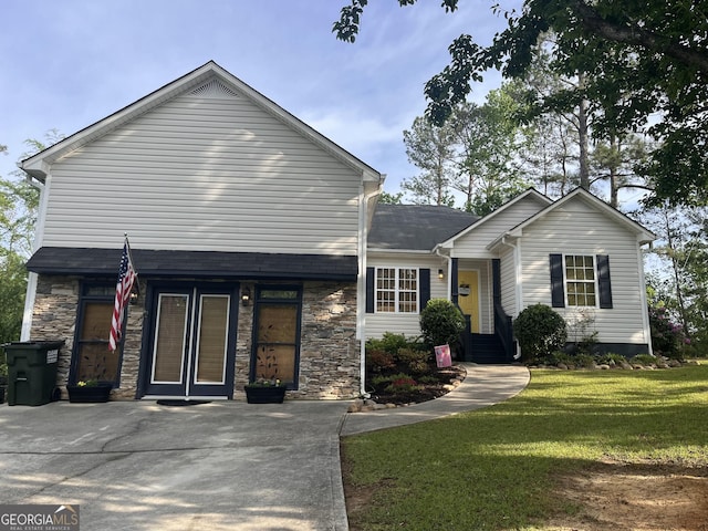 view of front of property with stone siding and a front yard
