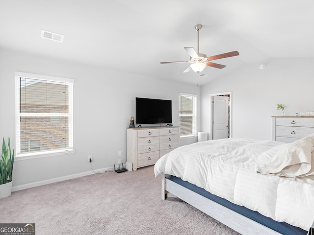 bedroom with light colored carpet, a ceiling fan, baseboards, lofted ceiling, and visible vents
