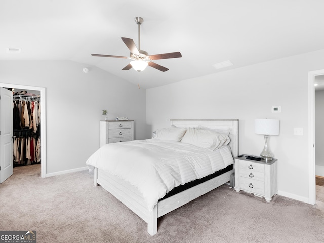 bedroom featuring baseboards, vaulted ceiling, and light colored carpet