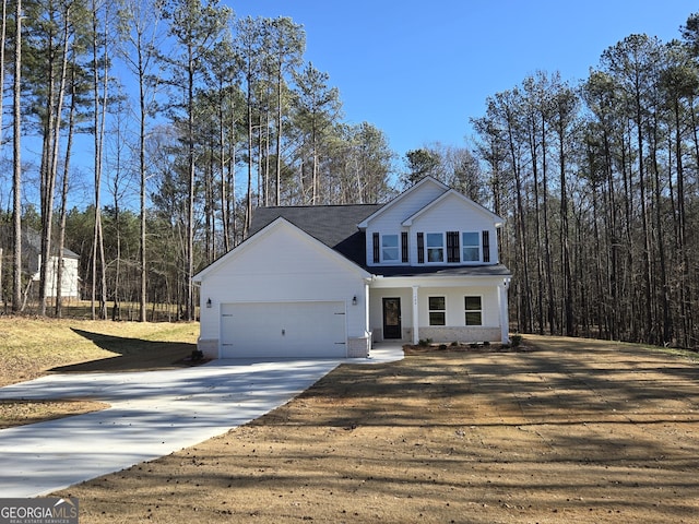 traditional-style house with a porch, an attached garage, and driveway