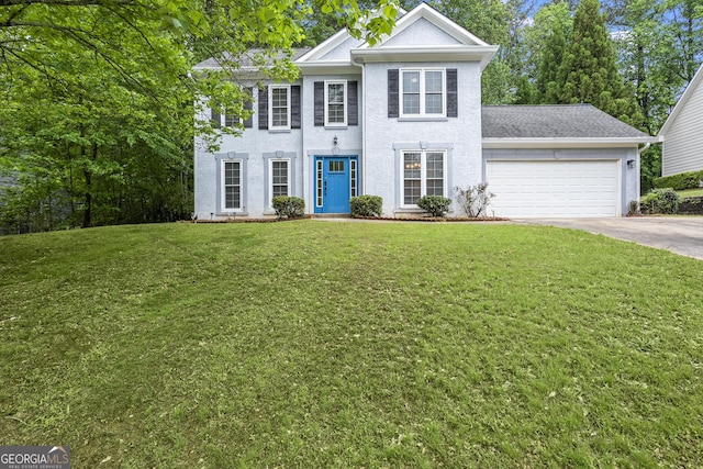 6939 Waters Edge Dr, Stone Mountain, GA 30087 - colonial home featuring a garage, stucco siding, a front yard, and concrete driveway