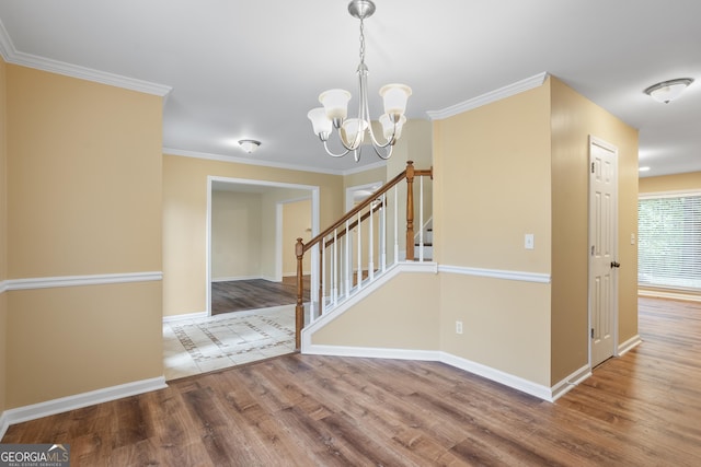 6939 Waters Edge Dr, Stone Mountain, GA 30087 - interior space featuring crown molding, baseboards, a notable chandelier, and wood finished floors