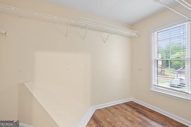 6939 Waters Edge Dr, Stone Mountain, GA 30087 - walk in closet with wood finished floors