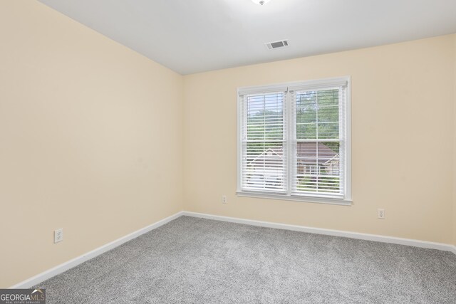 6939 Waters Edge Dr, Stone Mountain, GA 30087 - empty room featuring visible vents, carpet flooring, and baseboards