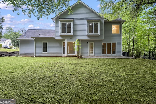 6939 Waters Edge Dr, Stone Mountain, GA 30087 - back of property with a lawn, central air condition unit, and a shingled roof
