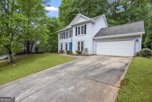 6939 Waters Edge Dr, Stone Mountain, GA 30087 - colonial house with a shingled roof, a front lawn, a garage, stucco siding, and concrete driveway