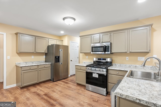 6939 Waters Edge Dr, Stone Mountain, GA 30087 - kitchen featuring light wood-style floors, a sink, appliances with stainless steel finishes, and light countertops