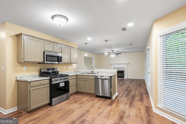 6939 Waters Edge Dr, Stone Mountain, GA 30087 - kitchen with a peninsula, a sink, appliances with stainless steel finishes, and gray cabinetry