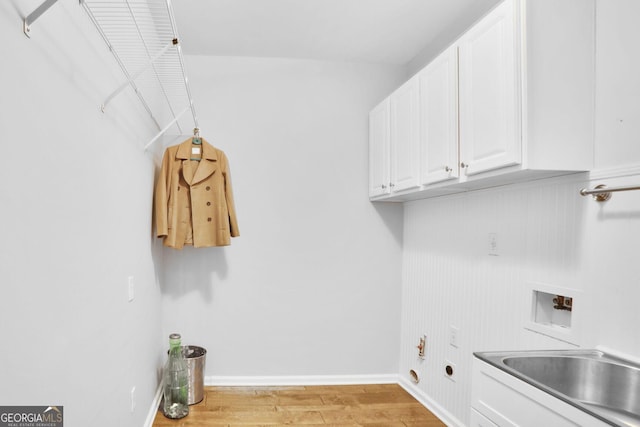 laundry area with cabinet space, a sink, light wood finished floors, hookup for a washing machine, and electric dryer hookup