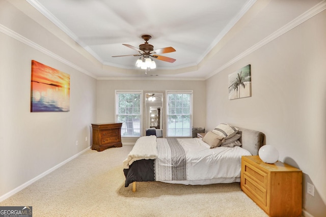 carpeted bedroom with crown molding, a raised ceiling, baseboards, and ceiling fan