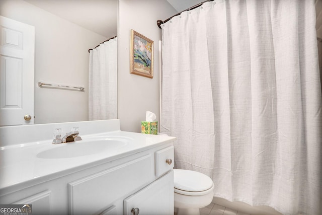 bathroom featuring vanity, tile patterned floors, toilet, and curtained shower