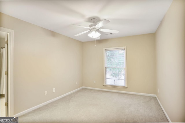 carpeted empty room featuring a ceiling fan, baseboards, and visible vents