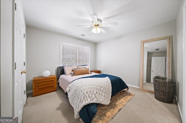carpeted bedroom with baseboards, a ceiling fan, and visible vents