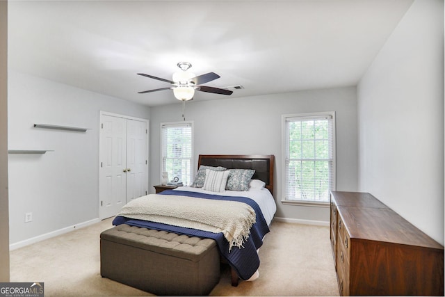 bedroom featuring baseboards, light colored carpet, ceiling fan, and visible vents
