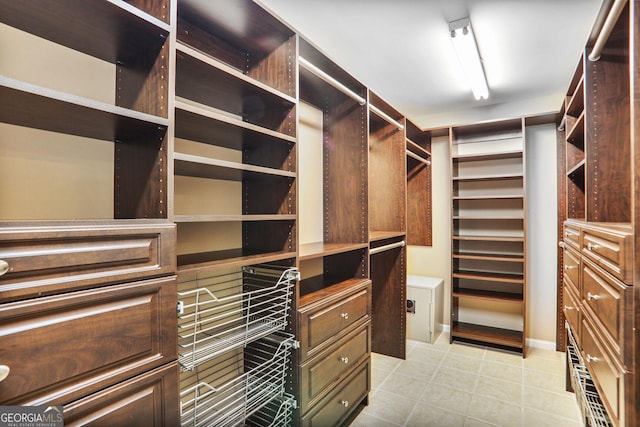 walk in closet with light tile patterned flooring