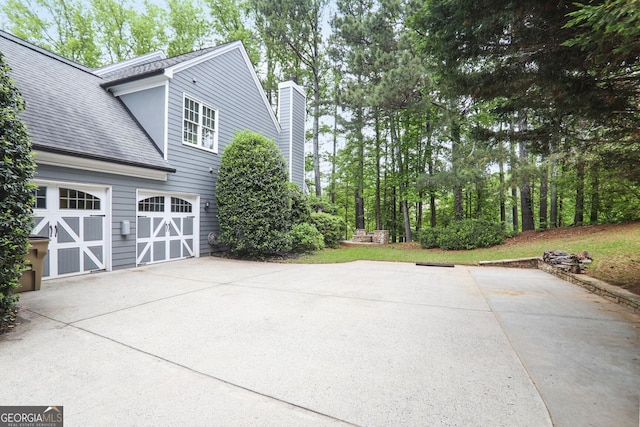 view of patio / terrace featuring driveway and a garage