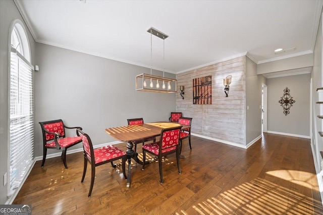 dining room with baseboards, ornamental molding, and wood-type flooring