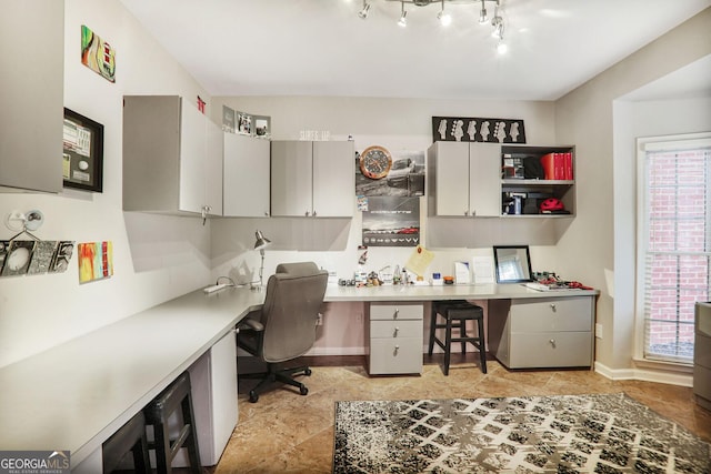 office space featuring built in study area and baseboards