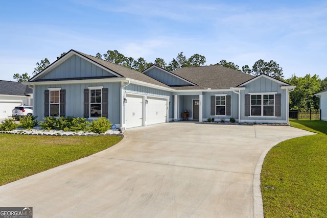 view of front of property featuring a garage, a front yard, roof with shingles, board and batten siding, and driveway