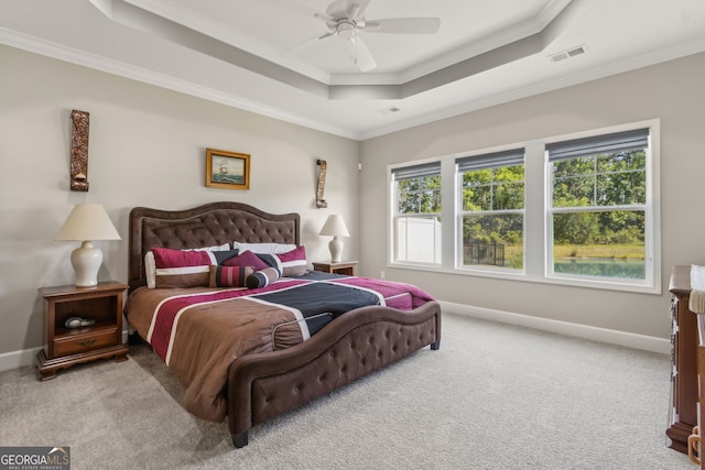 bedroom with visible vents, a raised ceiling, baseboards, ornamental molding, and carpet flooring