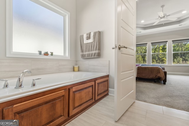 ensuite bathroom with tile patterned flooring, ensuite bath, a ceiling fan, baseboards, and a garden tub