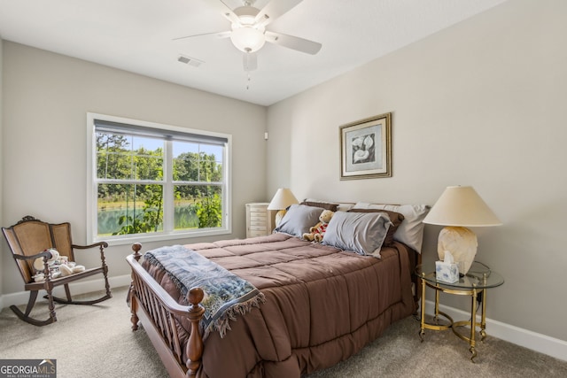 bedroom with a ceiling fan, baseboards, light colored carpet, and visible vents