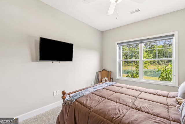 carpeted bedroom featuring a ceiling fan, baseboards, and visible vents