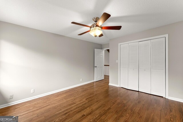 1155 Springway Dr, Gainesville, GA 30501 - unfurnished bedroom featuring a ceiling fan, baseboards, wood finished floors, and a closet