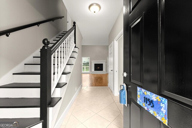 1155 Springway Dr, Gainesville, GA 30501 - entrance foyer with baseboards, stairs, light tile patterned flooring, and a fireplace