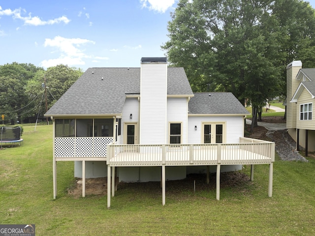 1155 Springway Dr, Gainesville, GA 30501 - rear view of house with french doors, roof with shingles, a trampoline, a wooden deck, and a yard